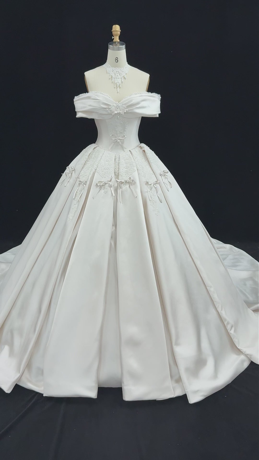 Charger la vidéo : Elegant Ivory Satin Princess Ball Gown Wedding Dress Off the Shoulder with Bow Accent SW675