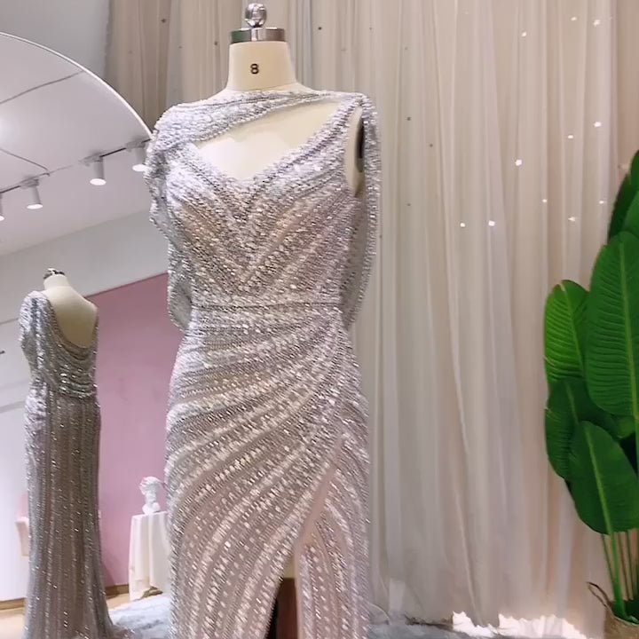 Video laden: Luxury Beaded Silver Slit Mermaid Evening Dress with Cape SS035