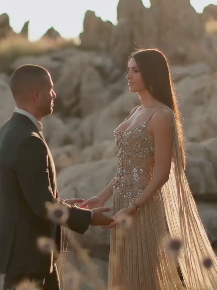 Video laden: Champagne Beaded Sheer Corset Evening Gown with Draped Cape &amp; Pleated Skirt SS538