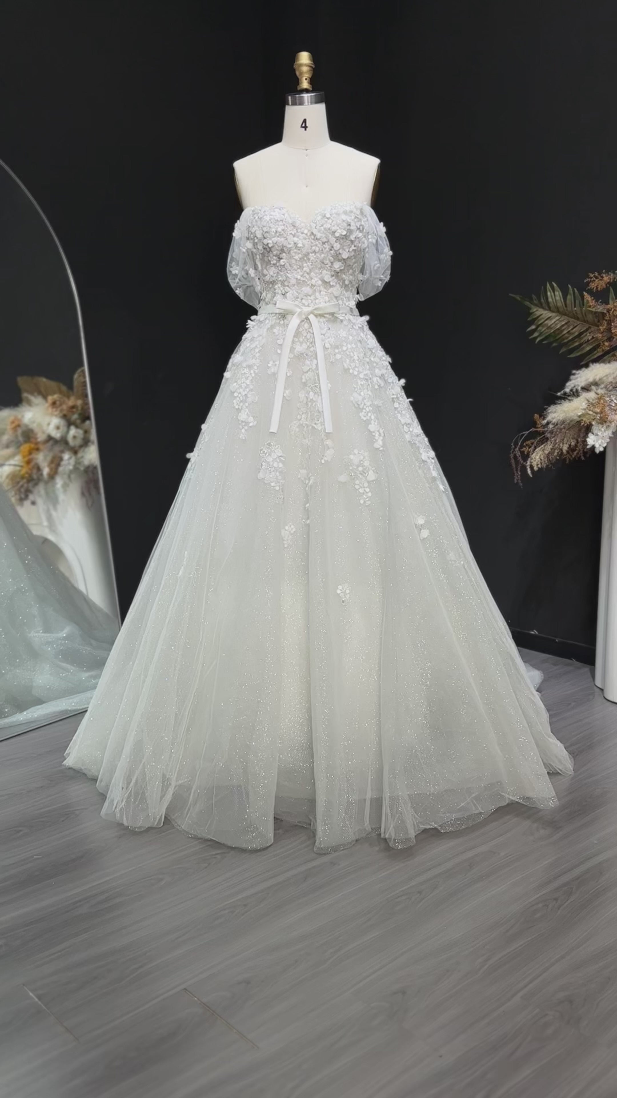 Video laden: White 3D Floral Applique Off the Shoulder A Line Wedding Dress SW629