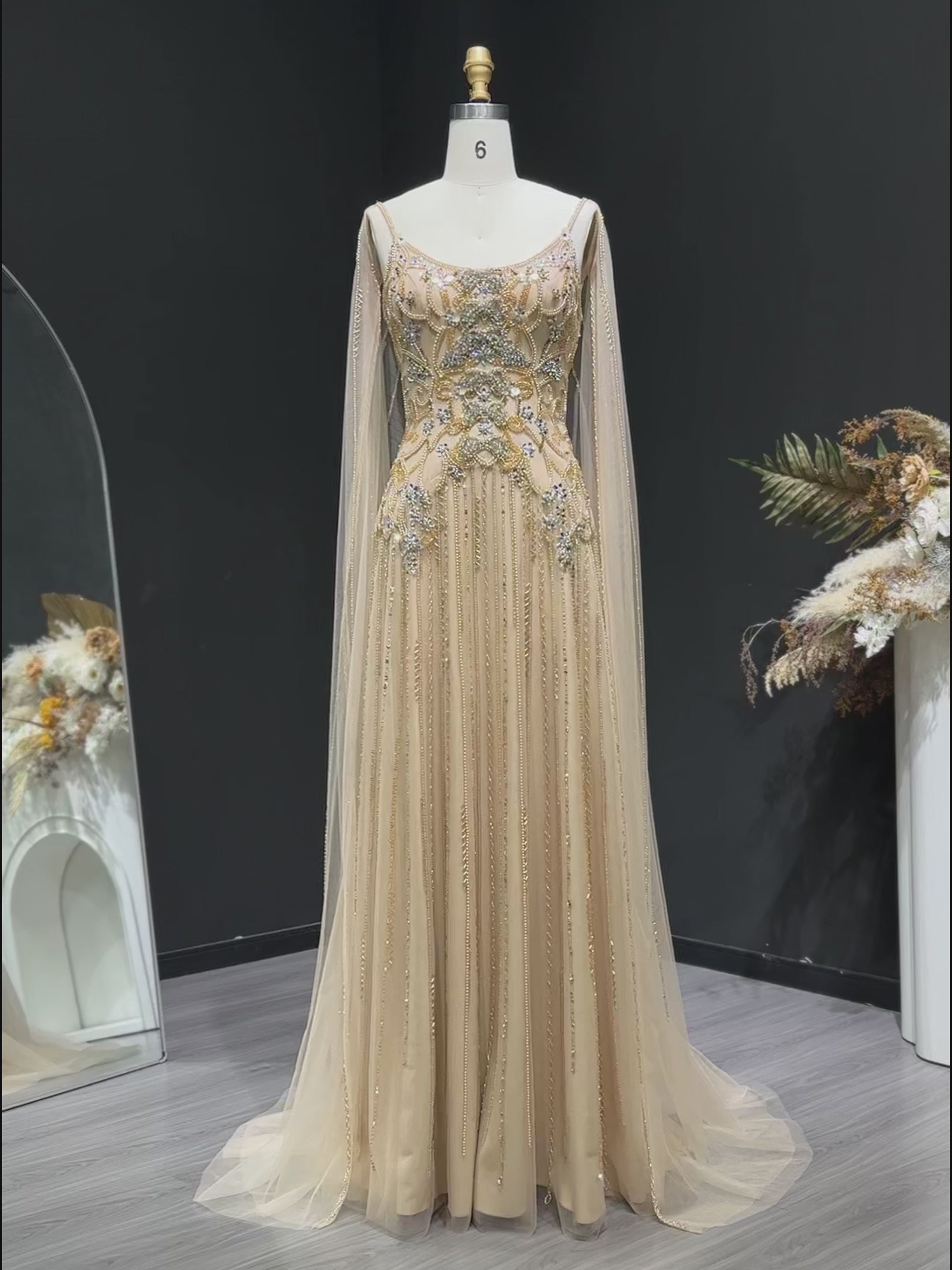 Video laden: Champagne Beaded Sheer Corset Evening Gown with Draped Cape &amp; Pleated Skirt SS538